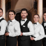 Group of trainees wearing formal clothes in hotel. Professional butler courses